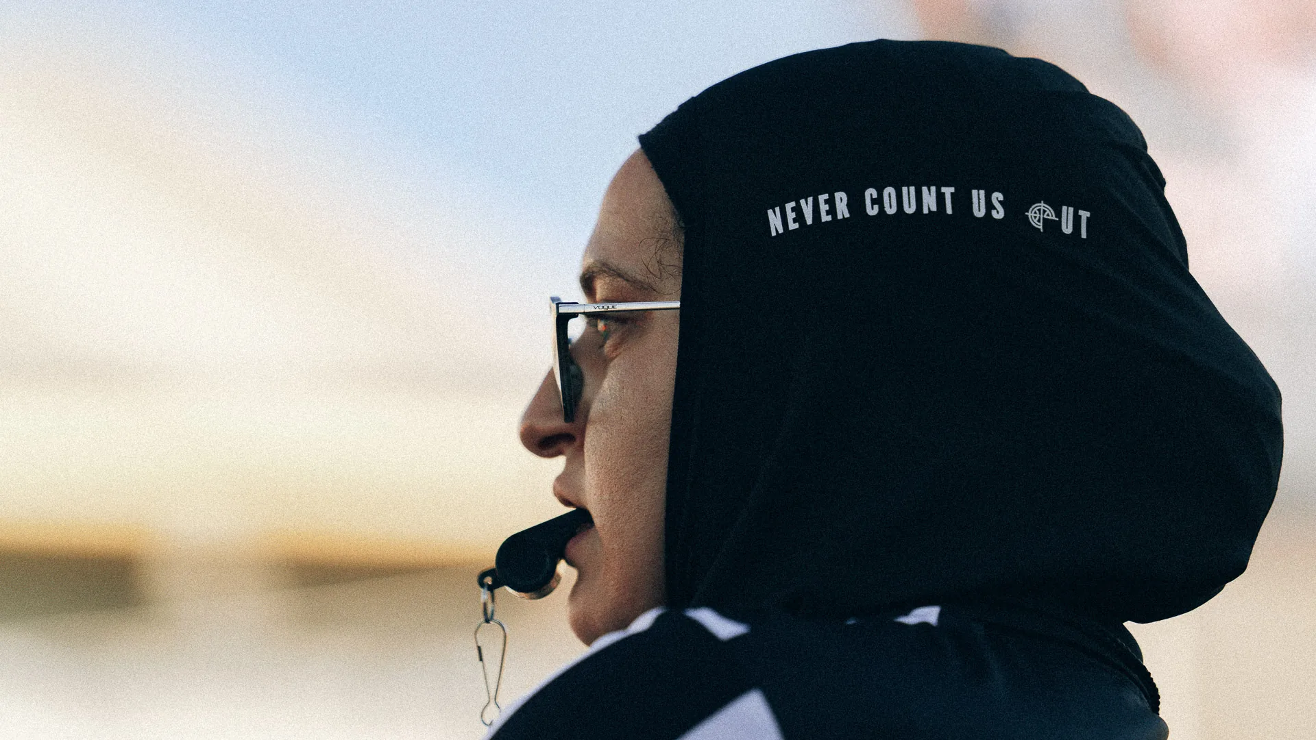 A referee in a hijab with a whistle at the 2024 main event